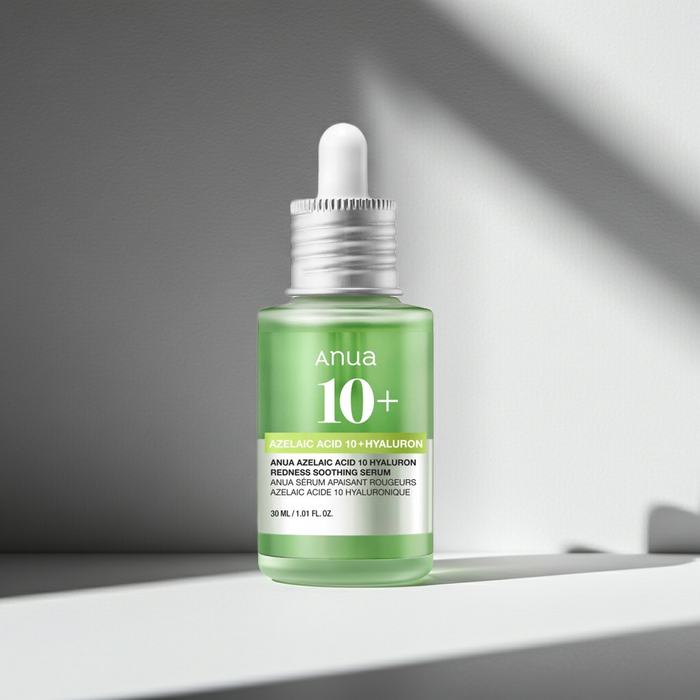 Green skincare serum bottle with dropper on a gray background