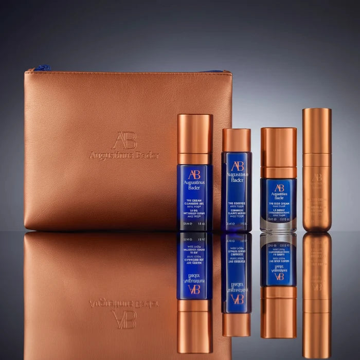 Augustinus Bader AB Essentials Set with copper case and four blue-and-gold skincare products