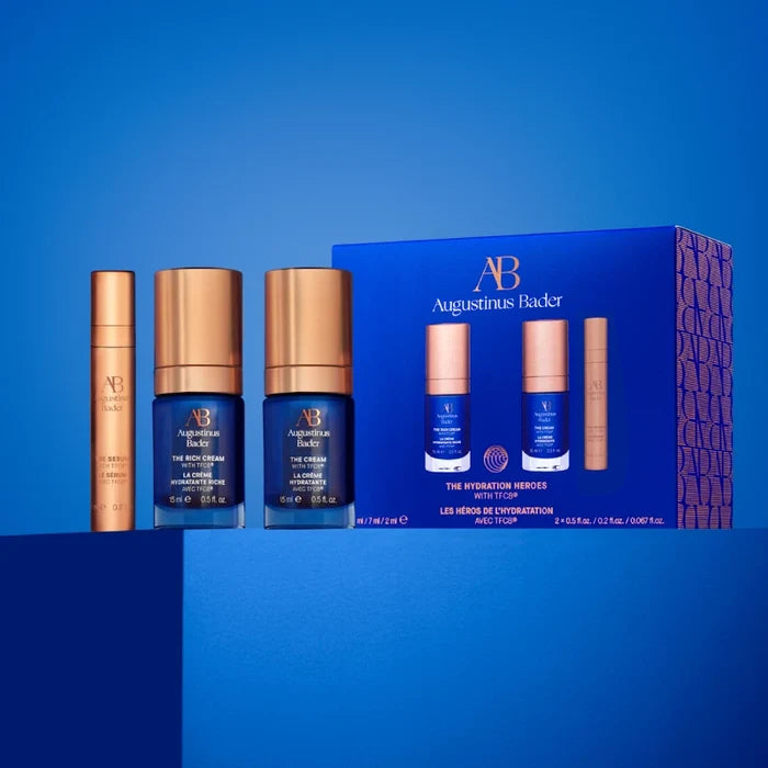 Augustinus Bader The Hydration Heroes Set with serum, cream, and moisturizer on blue box