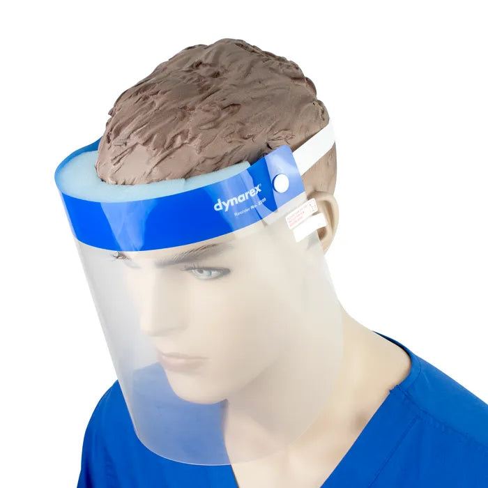A Dynorex Reusable Face Shield protects a mannequin's face against splashes. The shield is blue and clear, worn against a blue scrub top.