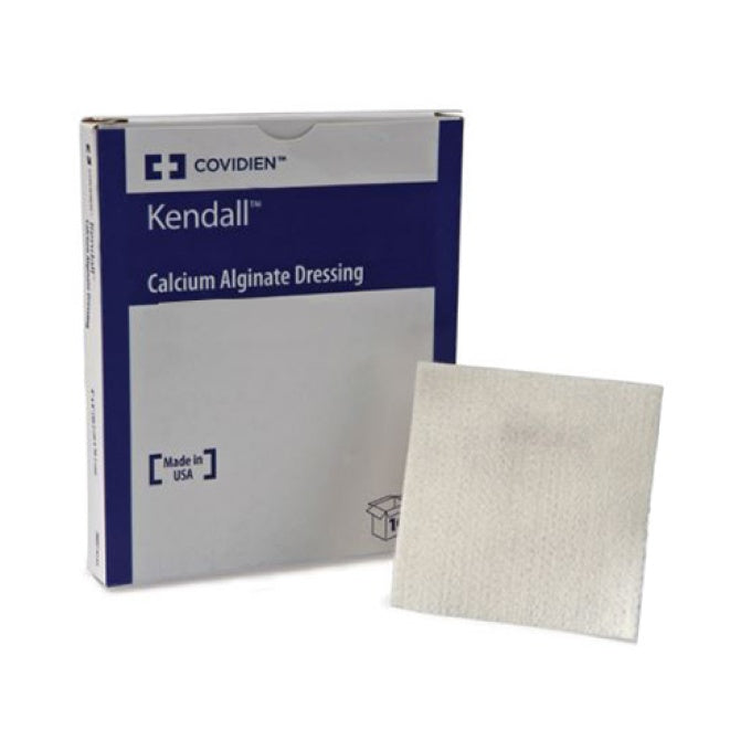A Kendall Calcium Alginate Dressing sits beside its box. The box displays the brand name "COVIDIEN" and "Made in USA".