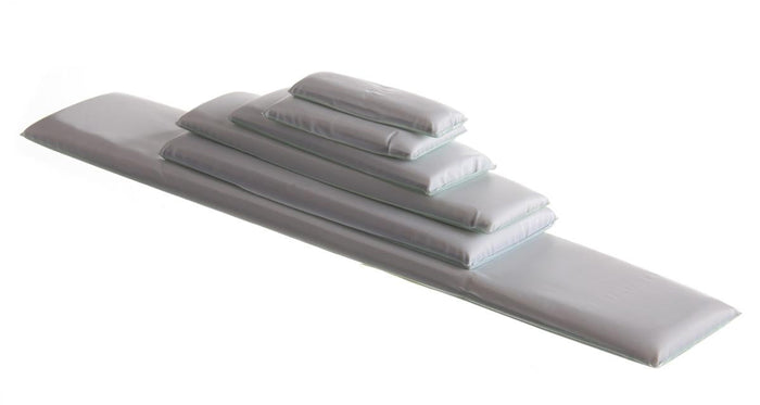 Rectangular foam pads of varying sizes are stacked, one atop the other, on a white background.