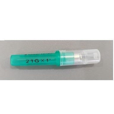 A capped needle, labeled "21G x 1"," lies horizontally on a gray surface. The cap is clear, while the base of the needle is green.