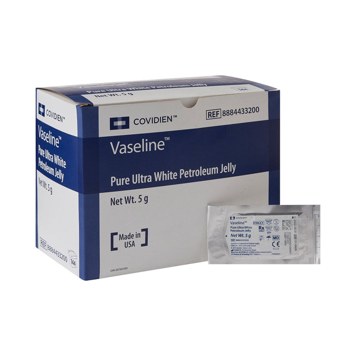 A box of Vaseline Pure Ultra White Petroleum Jelly sits next to a single packet of the same product. The box and packet are labeled with product information and reference number 8884433200. The box indicates it was made in the USA.