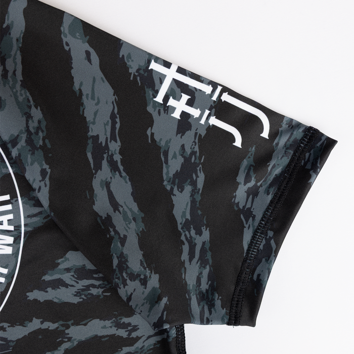 closeup of JJJ logo on sleeve of ladies camo rashguard