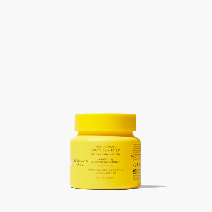 Yellow jar of Beekman 1802's 8 ounce Wonder Milk Buttery Botanical Jelly on a white background.