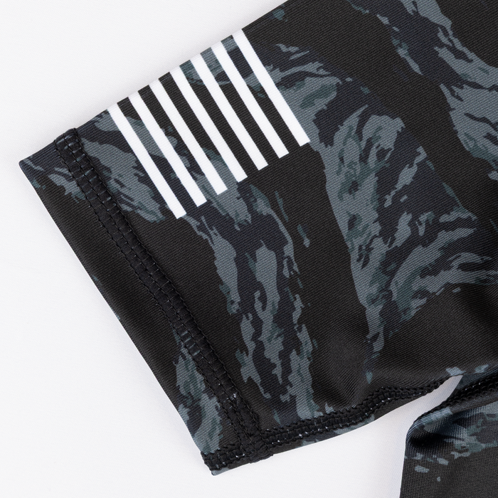 Flag graphic on sleeve of youth camo rashguard