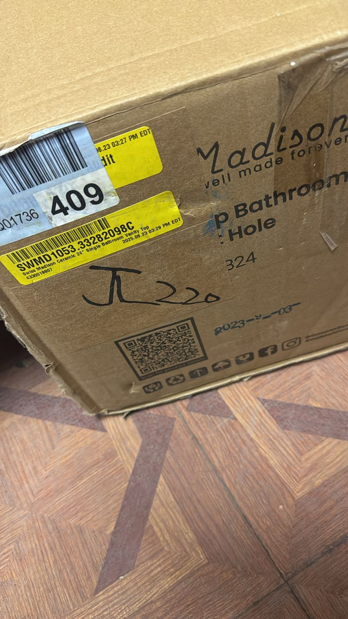 Cardboard box with shipping labels on a wooden floor