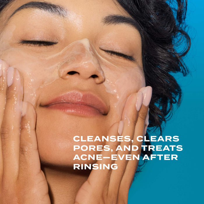 woman lathering cleanser on face on blue background with text overlaying that says cleanses, clears pores, and treats acne--even after rinsing