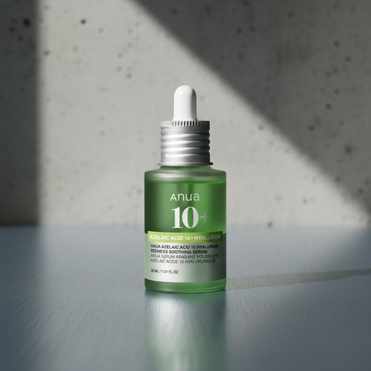 Green skincare serum bottle with dropper on a gray surface and textured wall background