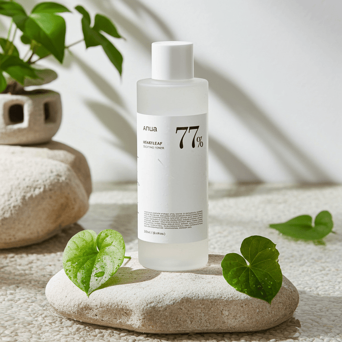Skincare bottle labeled '77%' on a stone with green leaves and plants in the background