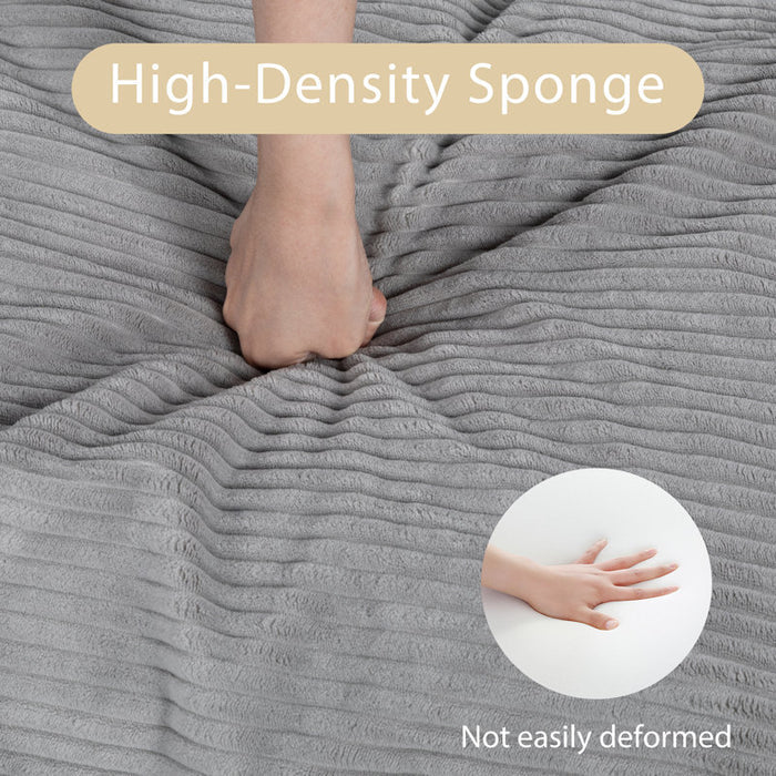 Gray high-density sponge with a hand pressing down and another hand showing the effect on a white background.