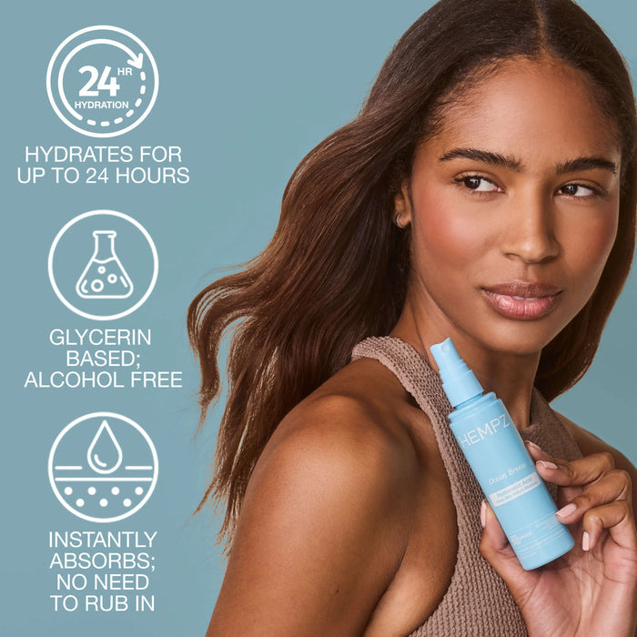 Woman holding Hempz Ocean Breeze Body Moisturizer Spray with Hyaluronic Acid bottle against a light blue background with claims