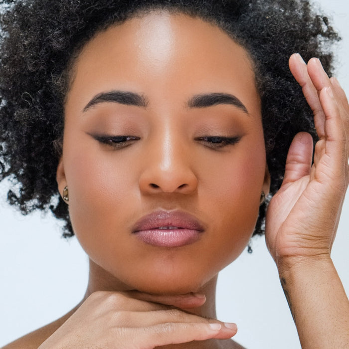 A woman wearing Demure Dark Brown Brow Liner