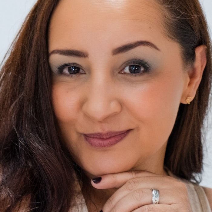 Latino woman wearing Demure Dark Brown Brow liner