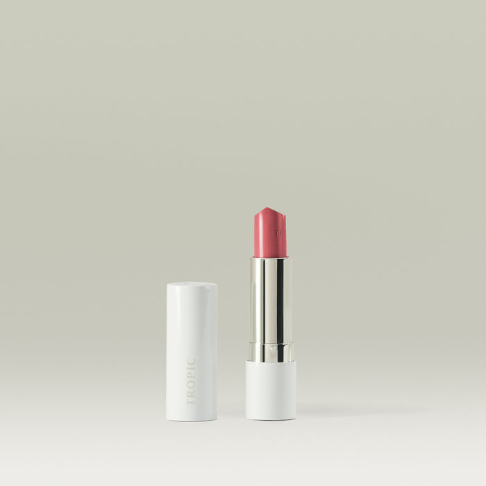 Tropic Butter Tint with pink shade displayed beside its white cap on a clean neutral background.