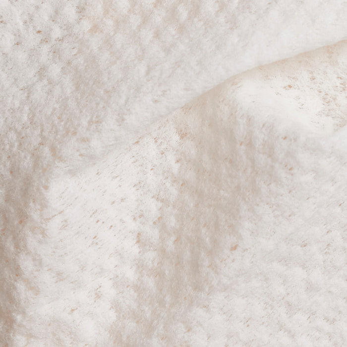 Up close shot of Beekman 1802's Lilac Dream Face Wipes, showing white towelette texture.