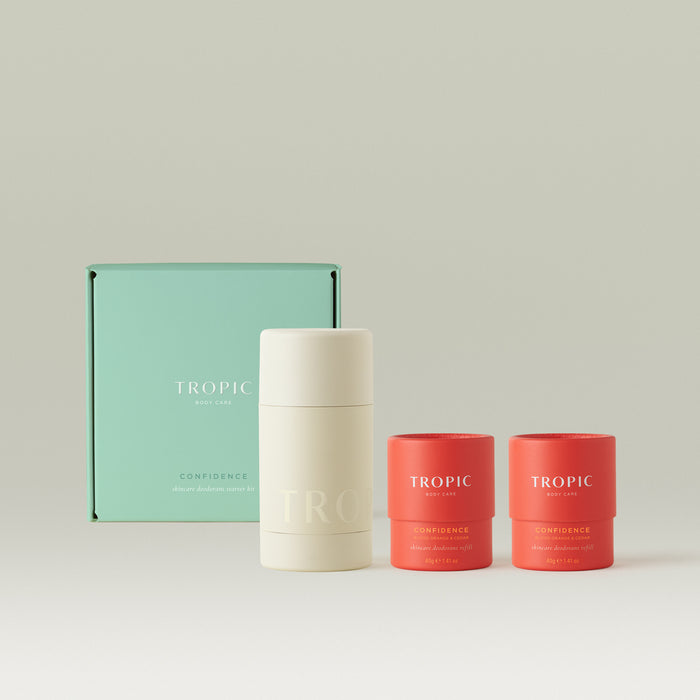 Tropic Confidence Skincare Deodorant Starter Kit with reusable applicator and two Blood Orange & Cedar refills in coral packaging.