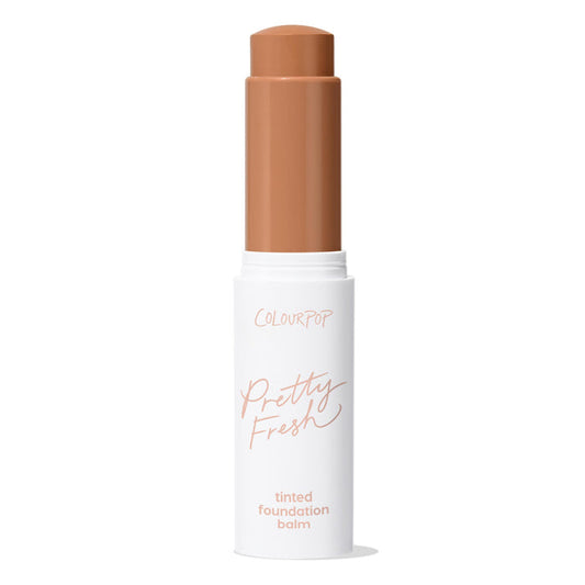 ColourPop Pretty Fresh Tinted Foundation Balm in Dark 18 - twist-up stick stands open with the warm deep shade bullet extended, housed in a white tube with peach lettering against a clean white background.