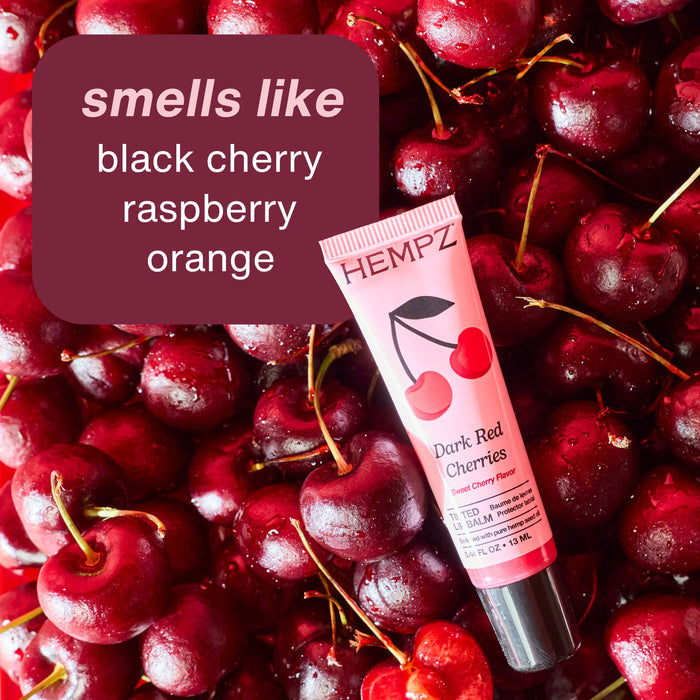 Hempz lip balm tube on a bed of cherries with flavor description text.
