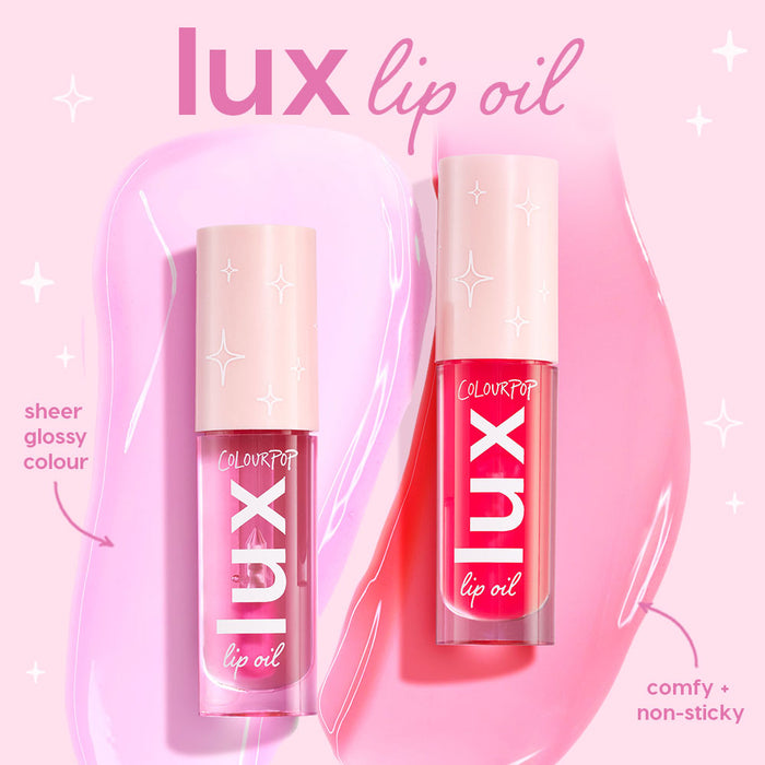 ColourPop Lux Lip Oil Dew Drop shown in two clear tubes standing upright, delivering sheer glossy color and comfy, non‑sticky shine, with pink swatches and star accents on a pastel background.
