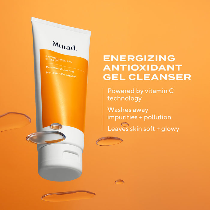 A squeeze tube of Murad Environmental Cleanse Gentle C Cleanser, featuring a white tube with a vibrant orange label, with text highlighting features like powered by vitamin c technology, washes away impurities + pollution, leaves skin soft + glowy on orange background