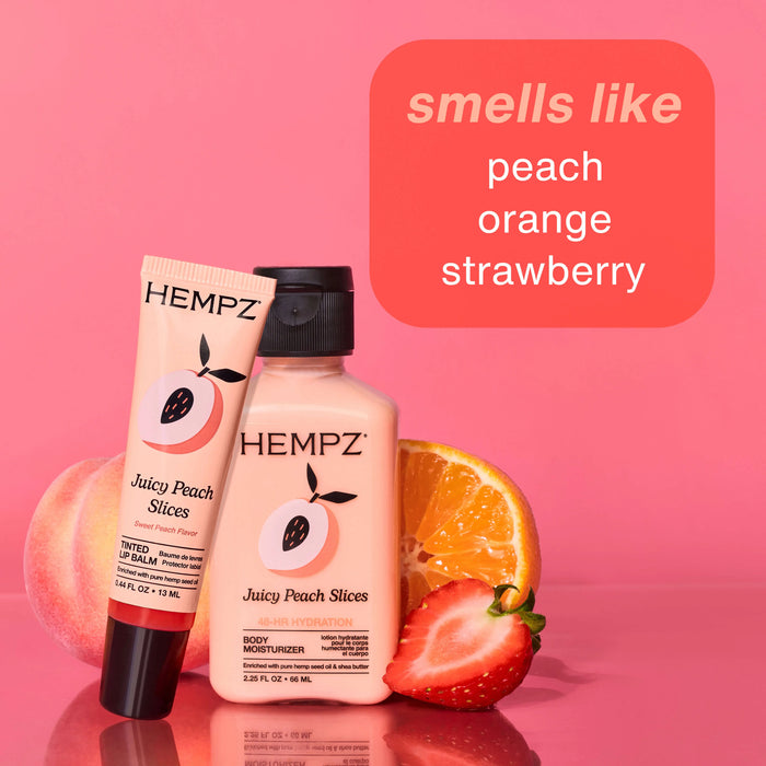 Hempz Juicy Peach Slices products with peach, orange, and strawberry on a pink background