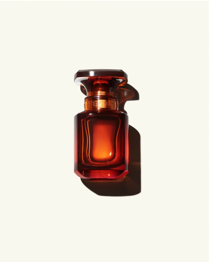 30ml Bottle of Fenty Eau de Parfumon a cream colored background.