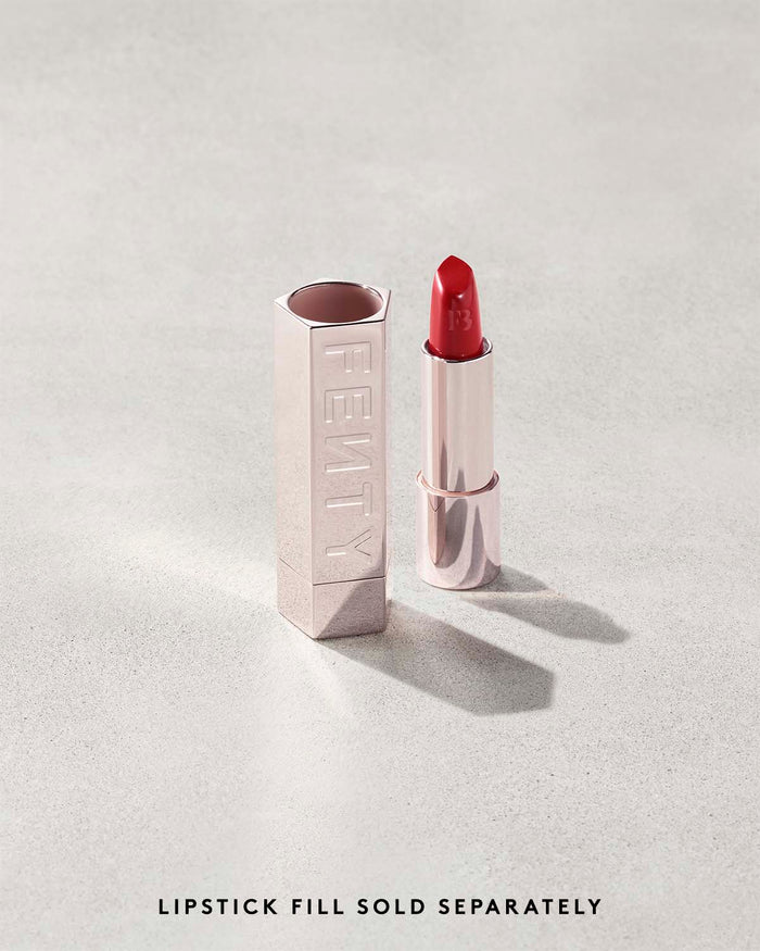 Fenty Icon lipstick shade in The MVP, next to a metallic lipstick case.