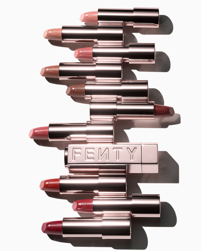 The 10 Fenty Icon lipstick shades displayed in open cases with a metallic refillable lipstick holder.