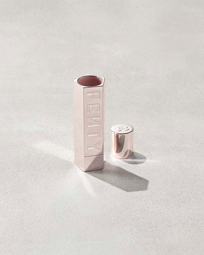An open Fenty Icon refillable lipstick holder in metallic.