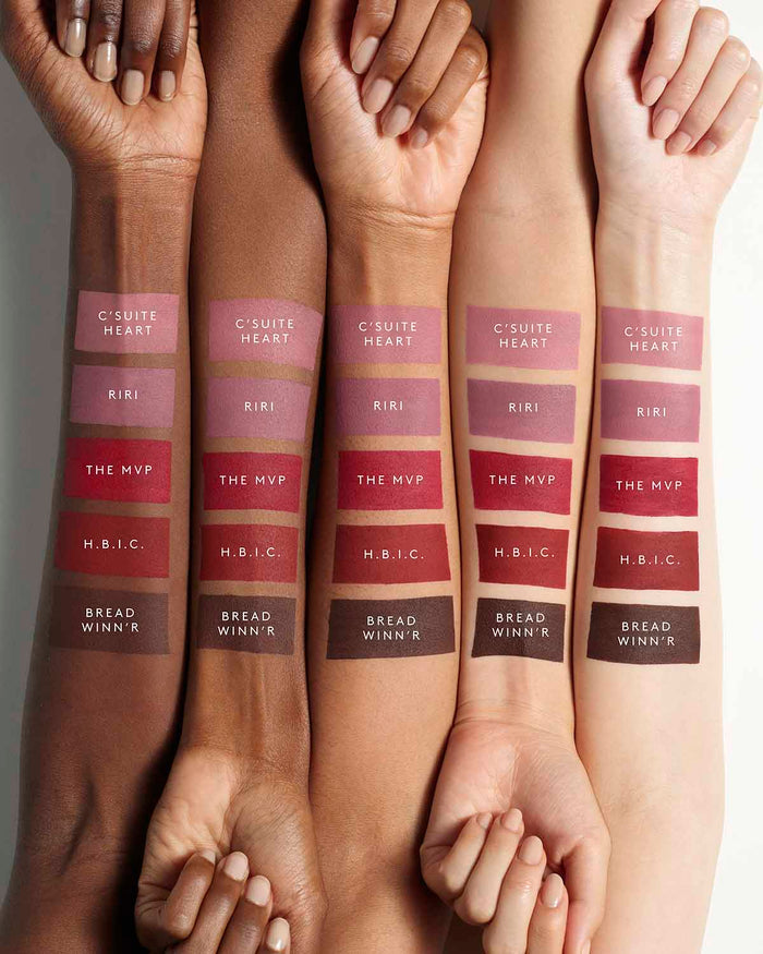 Arms of five models with different skin tones showing the Fenty Icon Velvet lipstick shades on each arm.