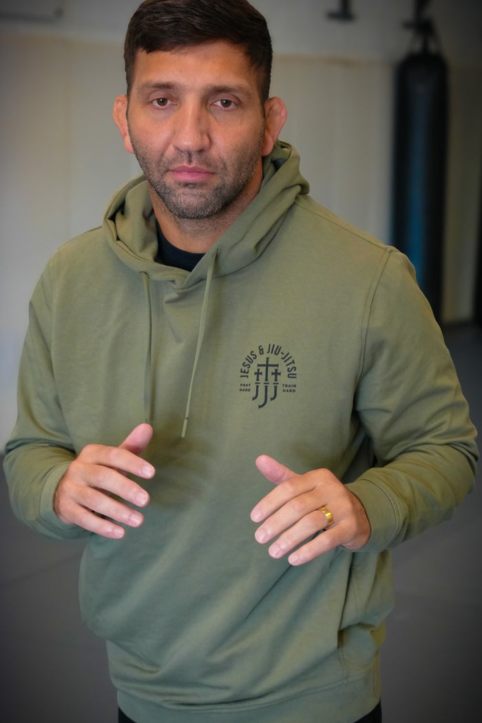 Man in pine hoodie with JJJ logo on left chest