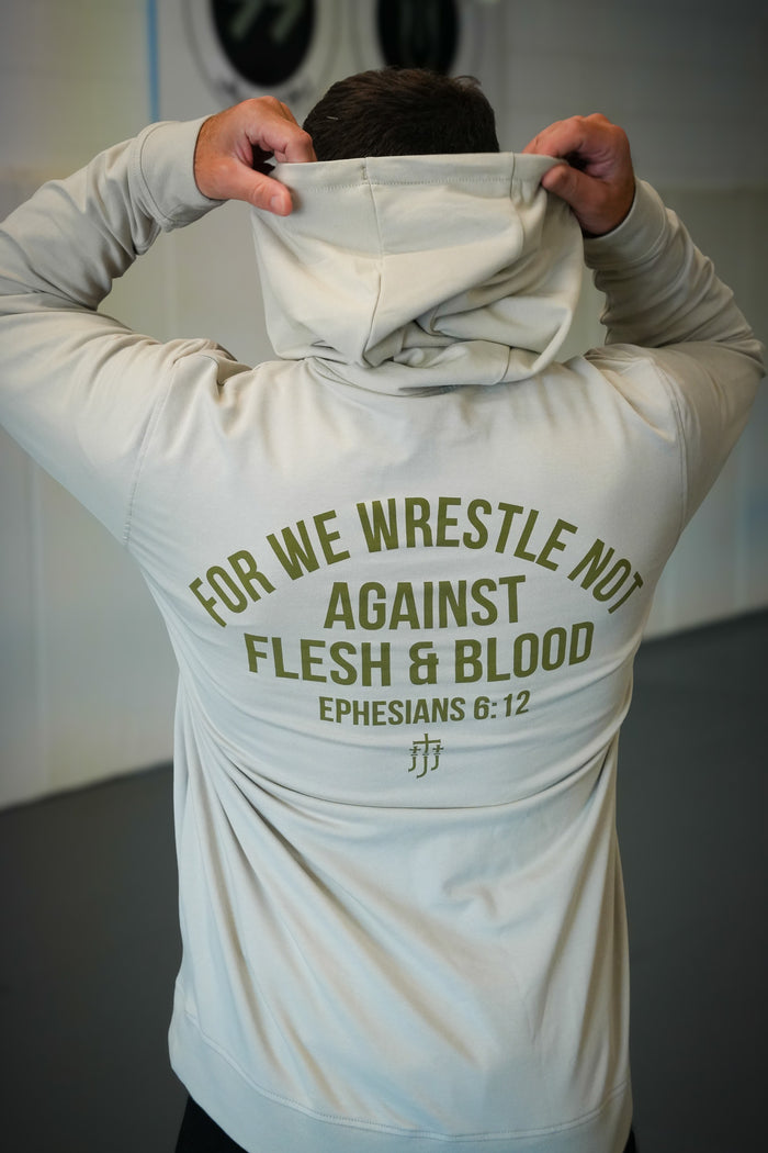 Rear view of man wearing smoke hoodie with text "FOR WE WRESTLE NOT AGAINST FLESH & BLOOD EPHESIANS 6:12"