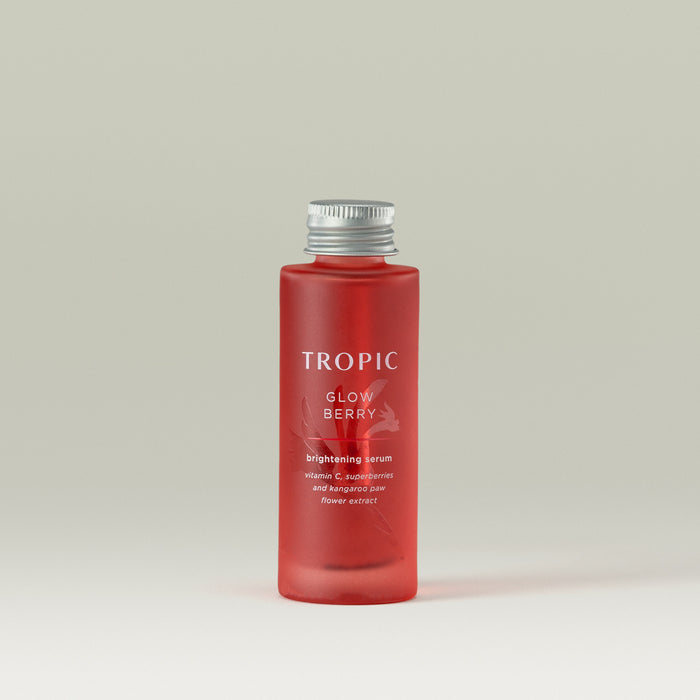 Tropic Glow Berry brightening serum Refill. Vitamin C, superberries and kangaroo paw flower extract. Deep red glass bottle with embossed floral design behind white text.