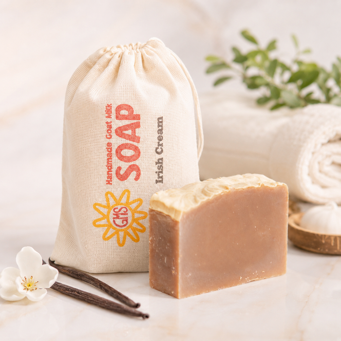 Bar of goat milk soap with a drawstring bag labeled 'Soap' on a light background