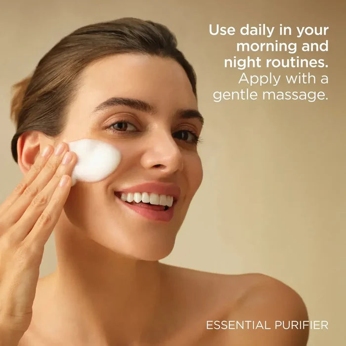 Woman applying ISDIN Essential Purifier foam cleanser to cheek with gentle massage