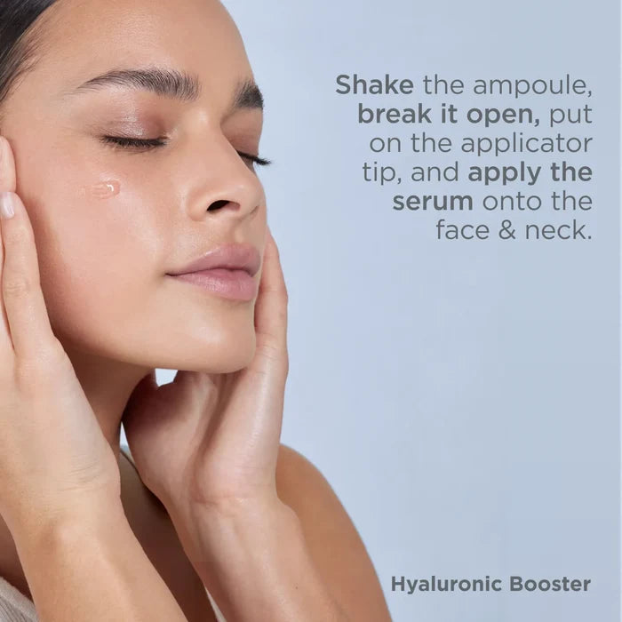 Woman applying Hyaluronic Booster serum to face and neck