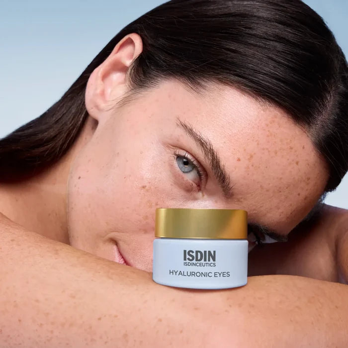 ISDIN Isdinceutics Hyaluronic Eyes jar beside a model's face for eye hydration care