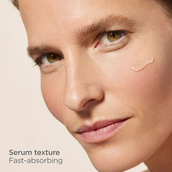 Woman applying fast-absorbing serum texture with hyaluronic acid on cheek