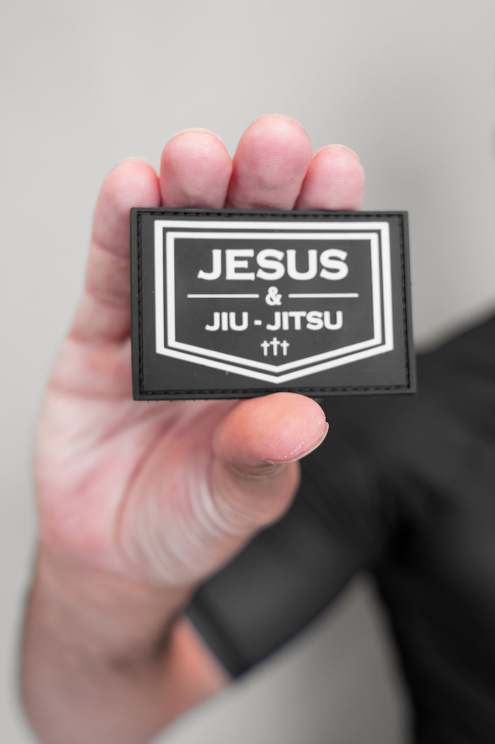 Person holding Velcro patch JJJ logo