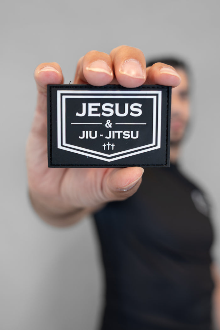Person holding Velcro patch JJJ logo