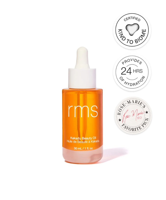 RMS Beauty Kakadu Beauty Oil in a clear orange glass dropper bottle with badges highlighting 24 hours of hydration, kind to biome certification, and a favorite pick endorsement.