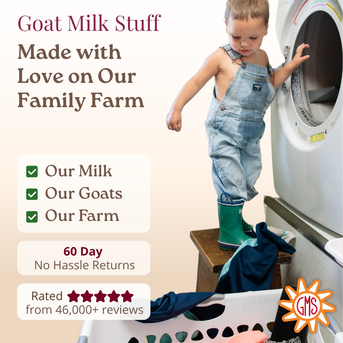 Child in denim overalls and green boots standing on a stool next to a washing machine with text about goat milk product and farm sourcing.