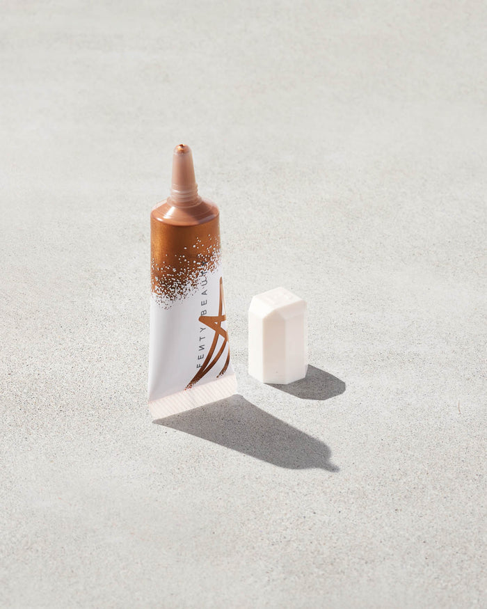 Tube of liquid highlighter in copper gold shade, Honey Hawtie.