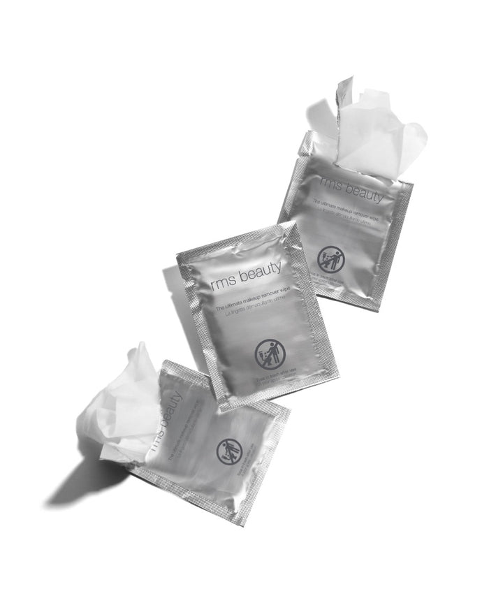Three silver packets of RMS Beauty Makeup Remover | Ultimate Makeup Remover Wipe with two partially opened wipes fanned out on a white background, highlighting clean and sustainable skincare.
