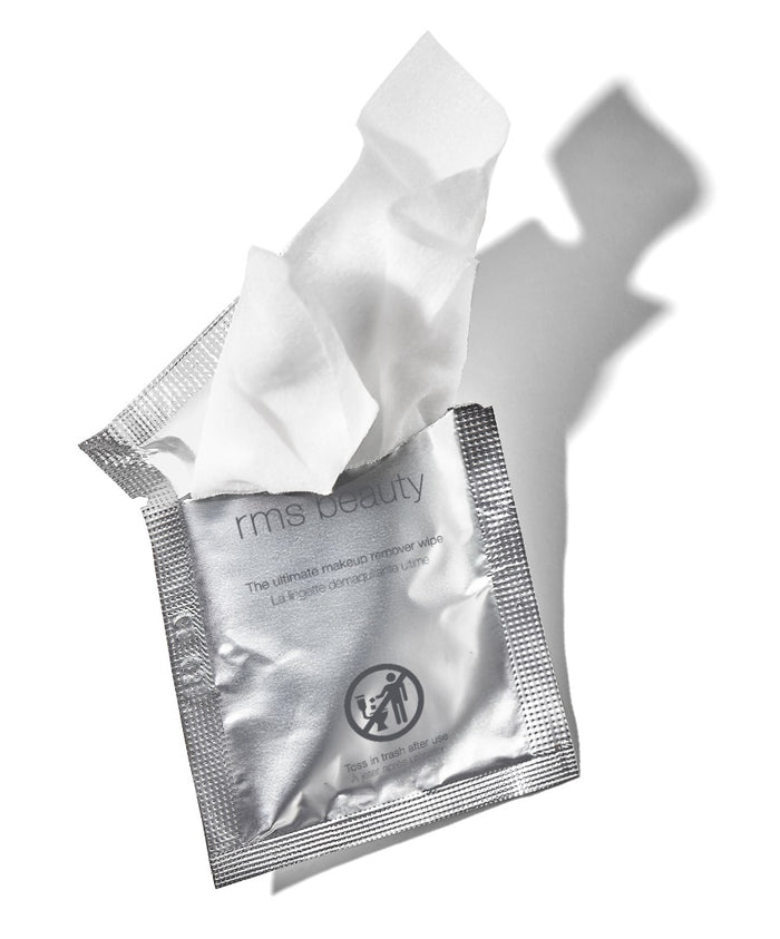 Single-use silver packet with a white makeup wipe partially pulled out, showcasing RMS Beauty's Makeup Remover | Ultimate Makeup Remover Wipe designed for clean beauty and skincare removal.