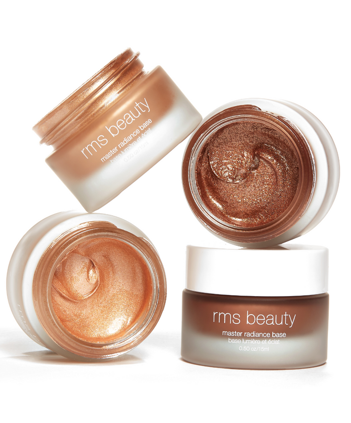 Four jars of RMS Beauty Master Radiance Base featuring shimmering cream makeup in bronze, copper, and gold tones in recyclable packaging, highlighting clean beauty and natural ingredients.