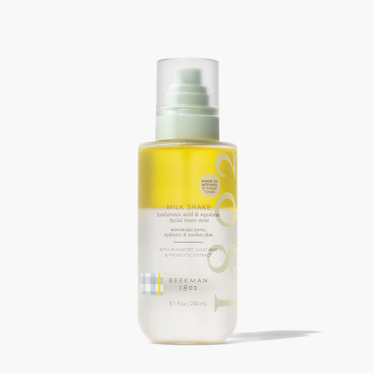 An image of the Beekman 1802 Milk Shake Hyaluronic Regular acid squalane facial toner mist on grey background