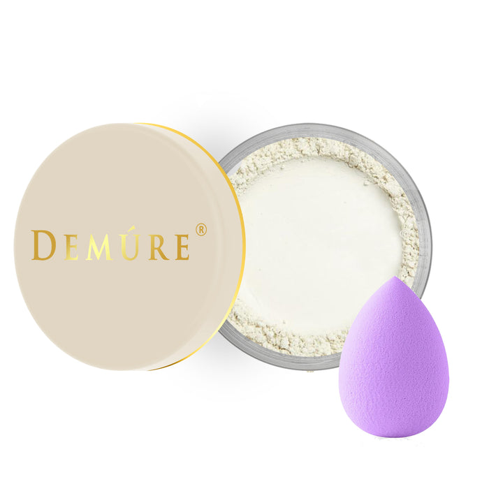 Open container of Demure Mint Concealer eye color with a gold lid. and a beauty blender applicator